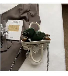 Internal view of beige lychee leather bag showing capacity for two phones and a lipstick