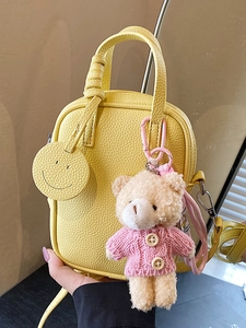 Yellow litchi leather mini crossbody phone bag with cute teddy bear and smiley face charm