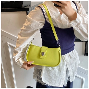 Detail of a bright yellow oil wax leather underarm bag with silver metallic clasp closure