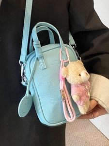 Light blue lychee pattern crossbody phone bag with cute bear charm and smiley tag