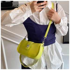 Detailed view of neon green oil wax leather underarm bag on model with silver buckle