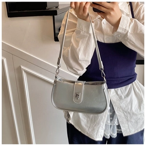Silver oil-wax leather baguette bag shown as a modern shoulder bag on a female model