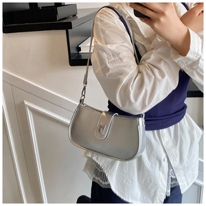 Close-up of the silver patent leather bag featuring a metallic turn-lock and sleek texture