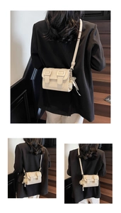 Close-up of beige textured leather mini bag with pearl beads and lace bow detail