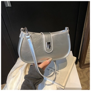 Detailed shot of silver crescent bag with metallic oil-wax finish and metal buckle