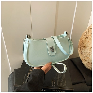 Close-up of mint green faux leather handbag with silver rotary metal lock