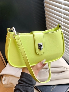 Neon green oil wax leather underarm bag with silver buckle shown in hand