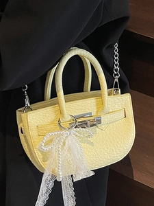 Chic yellow lychee pattern bucket bag with pearl bow charm and silver chain strap