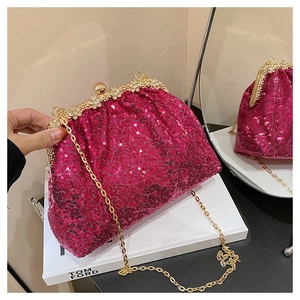 Détail de la pochette de soirée à paillettes rose fuchsia avec bordure dorée et fermoir fleur