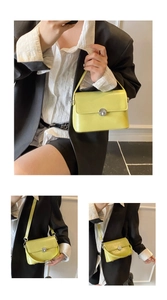 Lifestyle view of a lime yellow leather square bag with silver lock and shoulder strap
