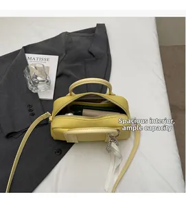 Detail view of yellow Boston bag interior with spacious compartment and leather texture