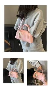 Detailed macro of pink lychee leather Boston bag with silk bow and silver metal chain