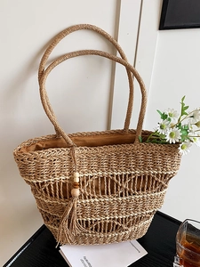 Bohemian hollow straw tote bag with beaded tassel detail for summer beach travel
