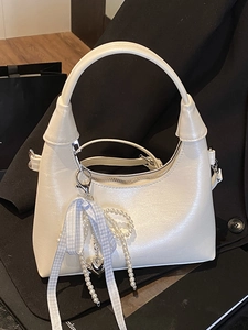 Chic cream white leather handbag with elegant pearl strap and heart charm detail