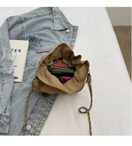 Internal view of khaki drawstring bucket bag showing storage capacity for phone and items