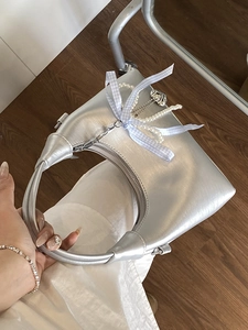 Silver metallic moon-shaped handbag with pearl charms and blue plaid bow detail