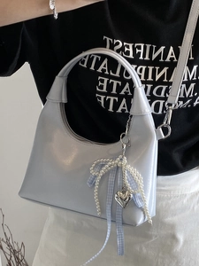 Minimalist light blue hobo bag with pearl bow pendant and adjustable silver hardware buckle