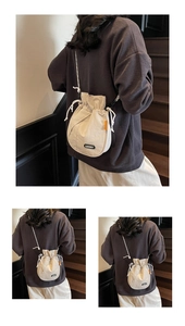 Detail view of the drawstring bucket bag showing the nylon fabric and Lucky label detail