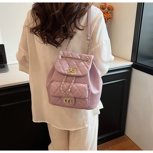 Detailed back view of a lavender quilted leather backpack with gold chain straps