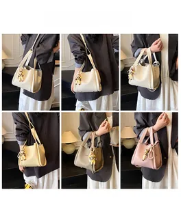 Detail view of stylish women's bucket bag in four colors with detachable shoulder straps