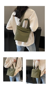 Detail view of grass green canvas tote bag with thick handles and detachable crossbody strap