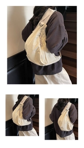 Detail of off-white hobo bag with braided drawstring zipper and wide shoulder strap