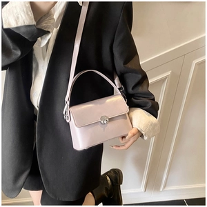 Detail of light purple glossy oil wax leather handbag with silver round metal twist lock