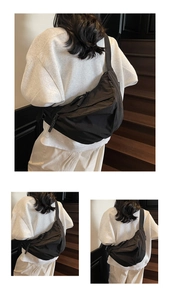 Detail of high-density nylon crescent bag with wide shoulder strap and woven zipper pull