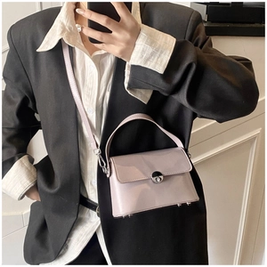 Detail of lavender oil wax leather handbag with silver twist lock and smooth glossy finish