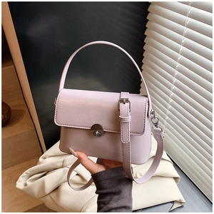 Detail of light purple oil wax leather handbag with metal turn-lock and crossbody strap