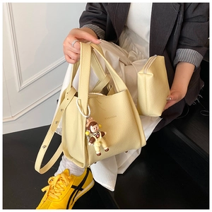 Litchi texture yellow handbag set with a small pouch and a cute monkey keychain
