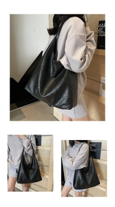 Close-up of black woven leather texture and spacious design on a commuter tote bag