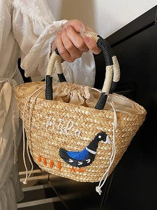 Chic woven straw handbag with cute duck embroidery and Hola lettering for beach travel