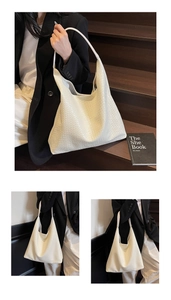 Detail of a large woven tote bag in creamy white leather with intricate textures
