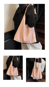Close-up of pink woven tote bag showing detailed texture and soft PU leather craftsmanship