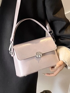 Minimalist lavender oil wax leather crossbody bag with silver rotating lock closure