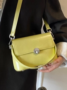 Lime green minimalist oil wax leather crossbody bag with silver rotating lock closure