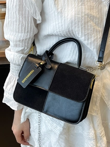 Chic black patchwork crossbody bag with matte suede texture and gold hardware detailing