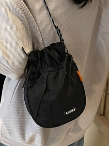 Japanese casual black drawstring bucket bag with Lucky patch and orange accents