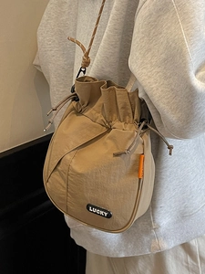 Casual khaki drawstring bucket bag with Lucky patch and shoulder strap for daily travel