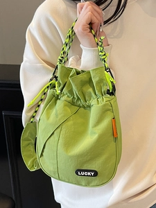 Grass green nylon drawstring bucket bag with black LUCKY patch and hiking rope strap