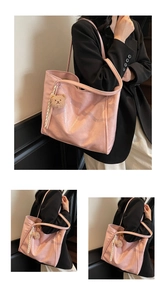 Pink oily leather tote bag detail with cute teddy bear charm and striped ribbon accent