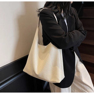 Close-up of cream white woven hobo bag showing large capacity and premium texture