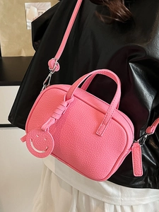 Pink grain leather pillow bag with smiley pendant and adjustable strap for women
