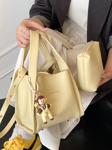 Chic pale yellow lychee texture tote bag with fashion text and cartoon pendant