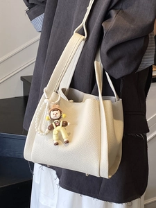 Chic beige lychee grain leather tote bag with pearl chain and doll charm for daily commute