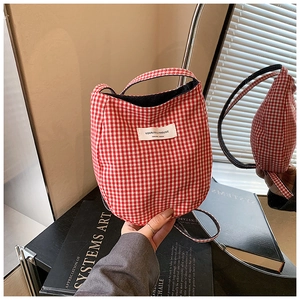 Close-up of red and white checkered cotton bag featuring a woven JOLLYHOUSE brand label