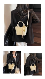 Detailed view of cream-white bucket bag with cute animal embossing and tassel accent