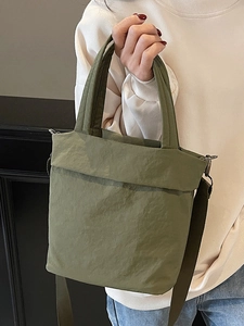 Army green nylon tote bag with pleated texture featuring top handles and shoulder strap