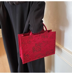 Detailed close-up of intricate red floral embroidery on the high-quality bridal tote bag
